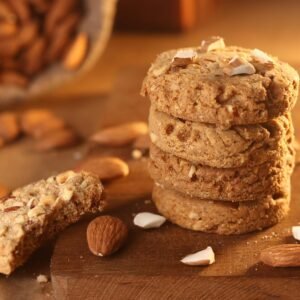 Delicious stack of almond chocolate chip cookies on a rustic wooden surface.