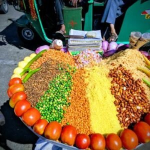 Vibrant street food display at a market in Jaipur showcasing traditional Indian snacks.